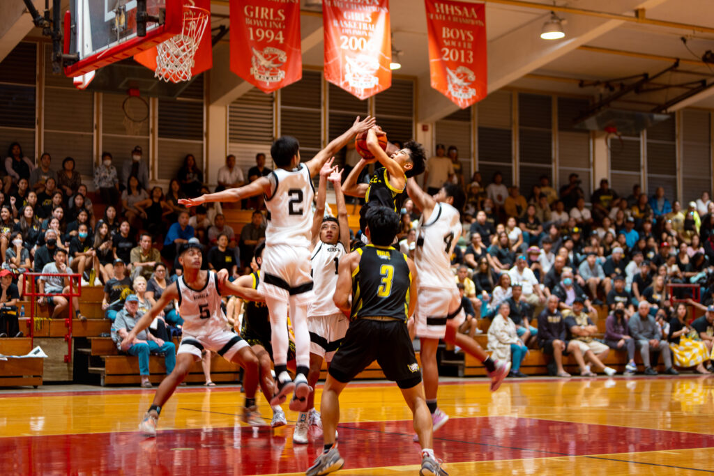 HBA's point guard Eli Shibuya is fouled as he attempts to score against Kohala in the semi finals of the Heide & Cook/Division II boys basketball championships on February 9, 2023. The Eagles lost 45-61 to Kohala and finished fourth in the championship. Photograph by Brendan Aoki ('24).
